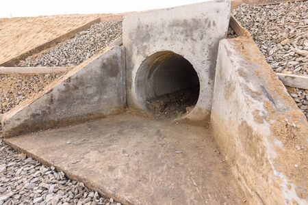 Installation of culvert drainage pipe and ditch structures under the highwayの写真素材