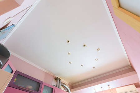 Stretch matte ceiling in the interior of the kitchen, the light is off
