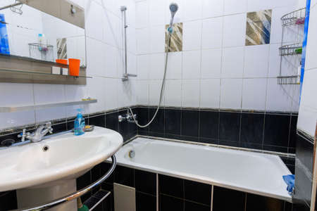 Classic bathroom interior in an apartment for daily rent, view of the bathroom and washbasin
