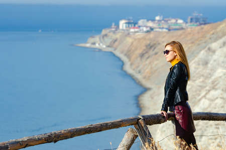 The girl examines the seascape from the mountain, close-up on the girlの写真素材