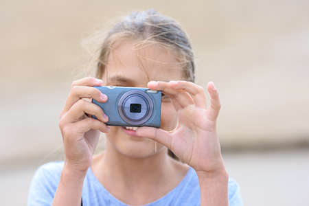Girl takes pictures with a digital camera