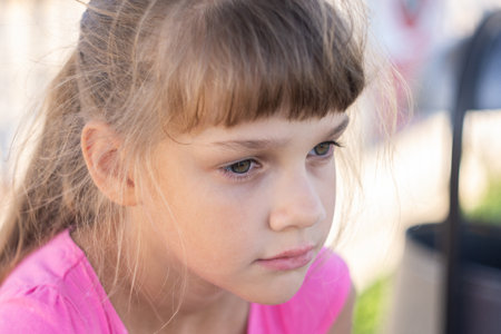 Portrait of a pensive European girl eight years oldの写真素材
