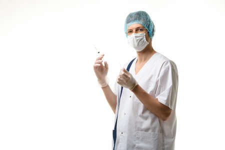 Surgeon holds a syringe in his hands and looked into the frame, isolated on white backgroundの写真素材
