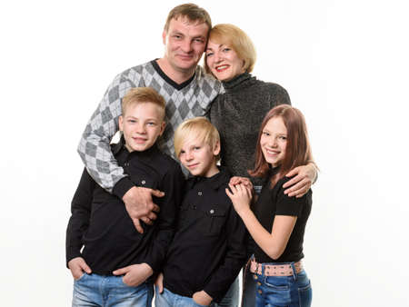 Happy growing up large family, two teenager boys and a girl, isolated on white backgroundの写真素材