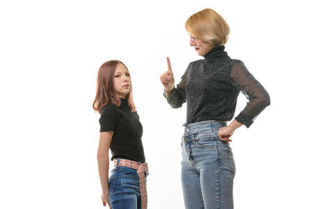 Woman punishing daughter for wrongdoing, isolated on white backgroundの写真素材