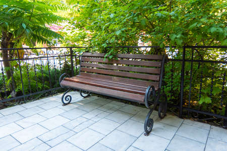 Beautiful forged bench in a well-maintained placeの写真素材