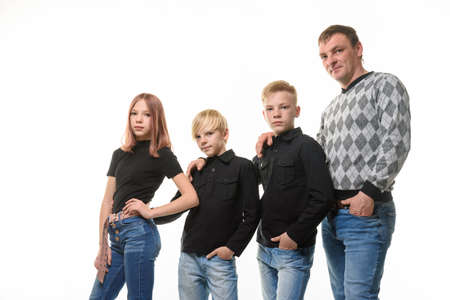 Dad, two sons and a daughter in casual clothes in dark colors, white backgroundの写真素材