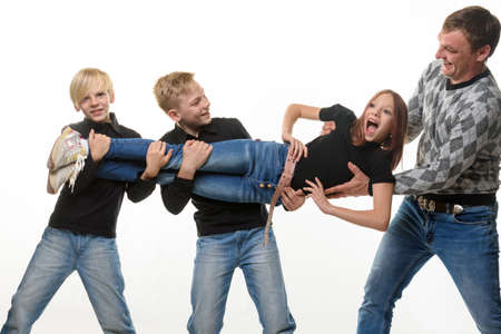 Dad and sons pull sister in different directions, white backgroundの写真素材