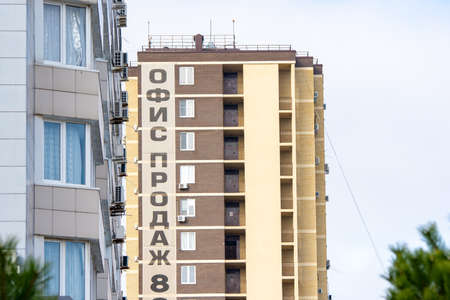 Banner "Builder's sales office" on the building of a new building put into operationの写真素材
