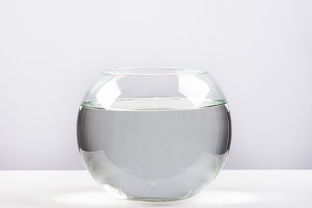 Round aquarium filled with clean water on a white backgroundの写真素材