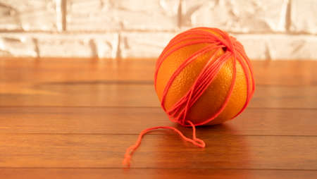 a ripe orange isolated on a yellow background, on a green background, on a red background, on a combined backgroundの写真素材