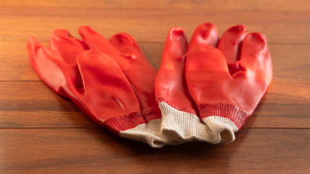 Hand in blue rubber glove with red capsule on white background. Doctor holding pill in hand. Selective focusの写真素材