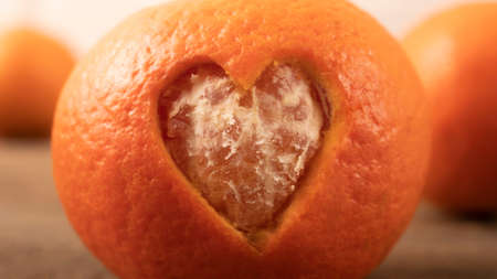 heart made of tangerine peel. postcard, note on a wooden background. gift in a red box