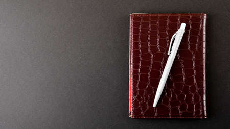Notebook and ballpoint pen isolated on white backgroundの写真素材