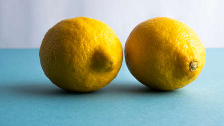 Lemons, two yellow lemon on a gray background. View from above.の写真素材