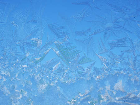 Abstract view of frost on the window surface. Blue crystal frosty texture. Cold winter background.の写真素材