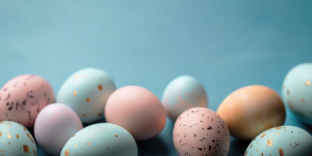 Pastel Easter eggs on blue background top view. Springtime holidays concept with copy space. Top viewの素材