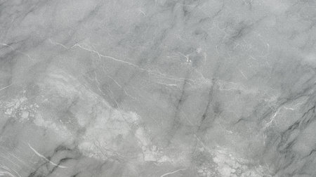 Smooth gray marble surface featuring delicate veining and a polished finish, perfect for use in design projects, backgrounds, and artistic endeavors showing elegance and styleの写真素材