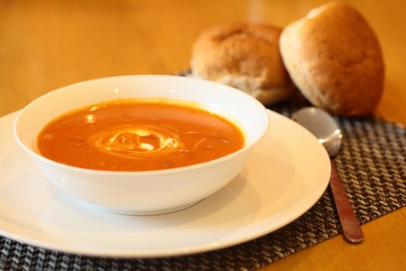 Hot Tomato Soup With Sour Cream In a Bowl with Spoonの写真素材