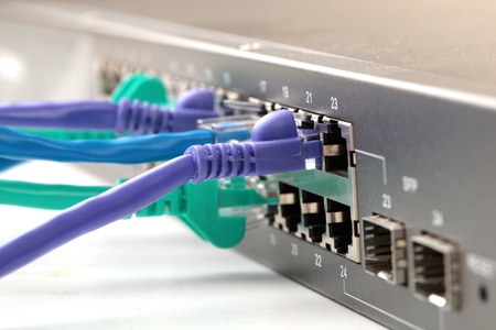 Colorful internet cables connected to network hubの写真素材
