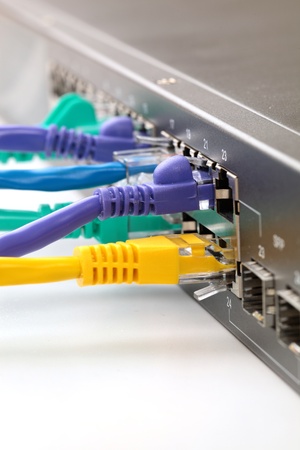 Colorful internet cables connected to network hubの写真素材