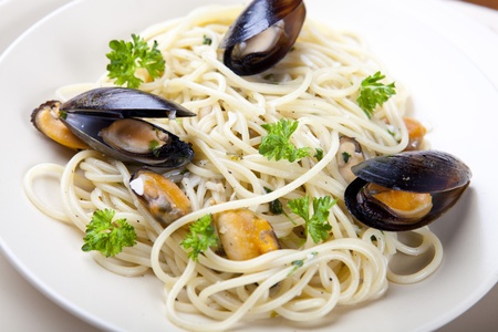 Spaghetti with Clam Sauce and Green Parsley on a Plateの写真素材