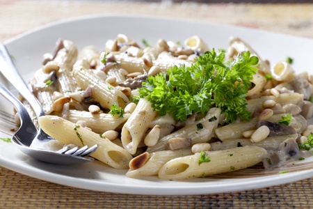 Vegetarian Pasta on a Plate with Fork and Spoon の写真素材