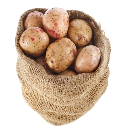 potatoes in burlap sack bag isolated over whiteの写真素材