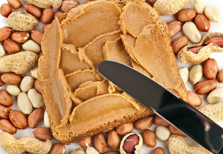 peanut butter sandwich with knife on white backgroundの写真素材