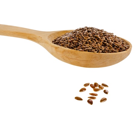 flax seed linseed in wooden spoon closeup isolated on white backgroundの写真素材