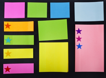 empty colored memo sticky paper notes on black backgroundの写真素材