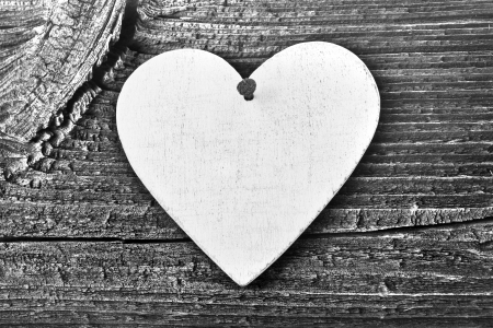 Love heart hanging on wooden texture background, valentines day card conceptの写真素材