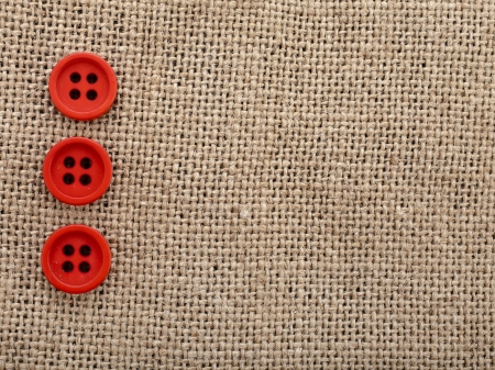 canvas burlap background texture with red buttons