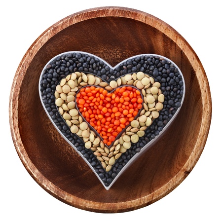 soybean and a variation of lentils in a wooden bowl isolated on white backgroundの写真素材