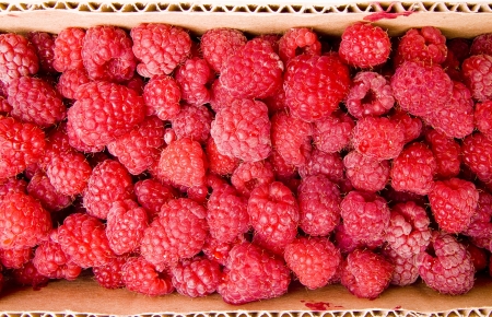 Raspberries in the cardboard box background