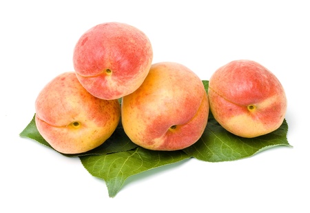 apricots fruits with leaves close up isolated on white backgroundの写真素材