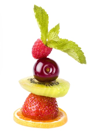 pyramid of fruit and berries stack tower close up isolated on white backgroundの写真素材