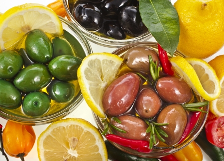 olives dish with variety vegetables, herbs, spices top view close up on a white backgroundの写真素材