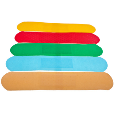 colored adhesive bandage plaster close up macro , isolated on a white backgroundの写真素材