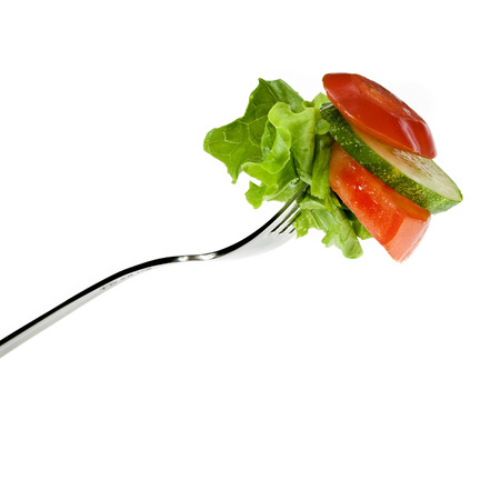 Fork with salad from vegetables isolated on whiteの写真素材