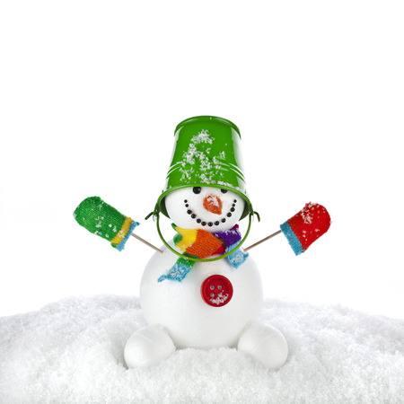 funny snowman with green color bucket on his head isolated on white の写真素材