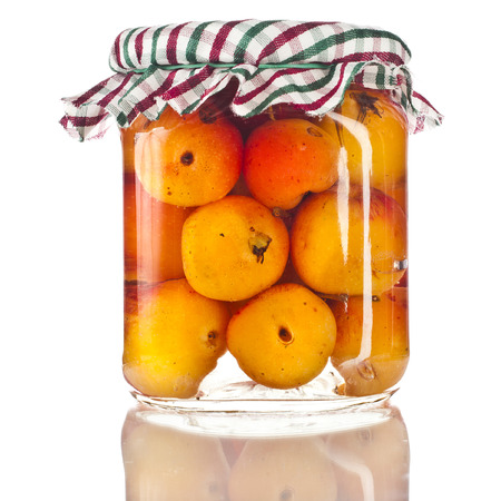 Apples in glass jar close up isolated on a white backgroundの写真素材