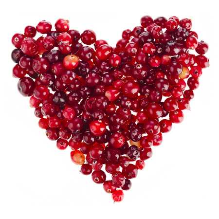 ripe cranberries in the form heart surface top view isolated on white backgroundの写真素材