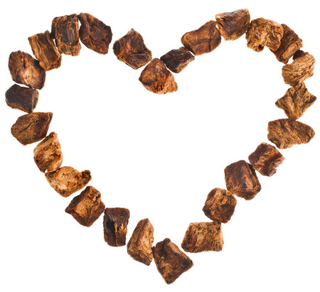 Chicory root in shape heart frame isolated on white の写真素材