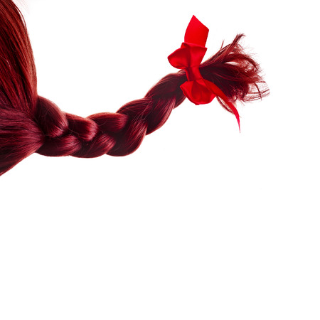 natural hair braided with red ribbon bow isolated on white の写真素材