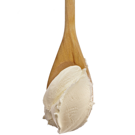 White cream on wooden spoon top view surface Isolated on White Backgroundの写真素材