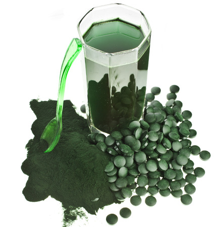 Spirulina algae powder glass drink nutritional supplement close up , isolated on white backgroundの写真素材