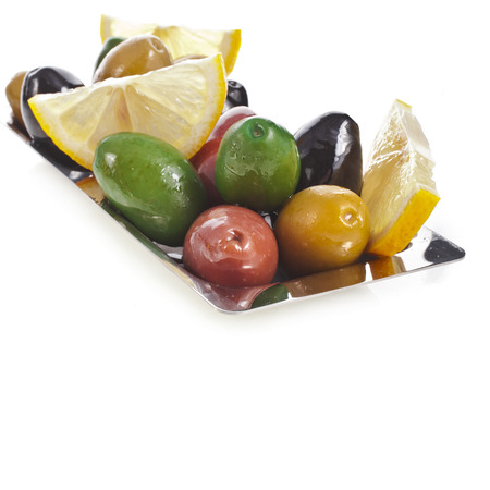 olives dish with vegetables, herbs, spices isolated on a white backgroundの写真素材