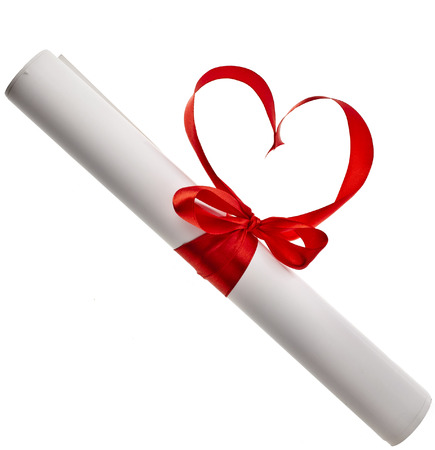 Graduation diploma with red ribbon shape heart symbol valentines day isolated on white backgroundの写真素材