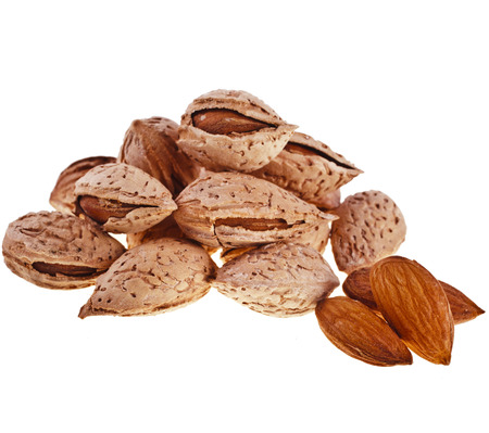 Almond seeds heap close up isolated on white backgroundの写真素材